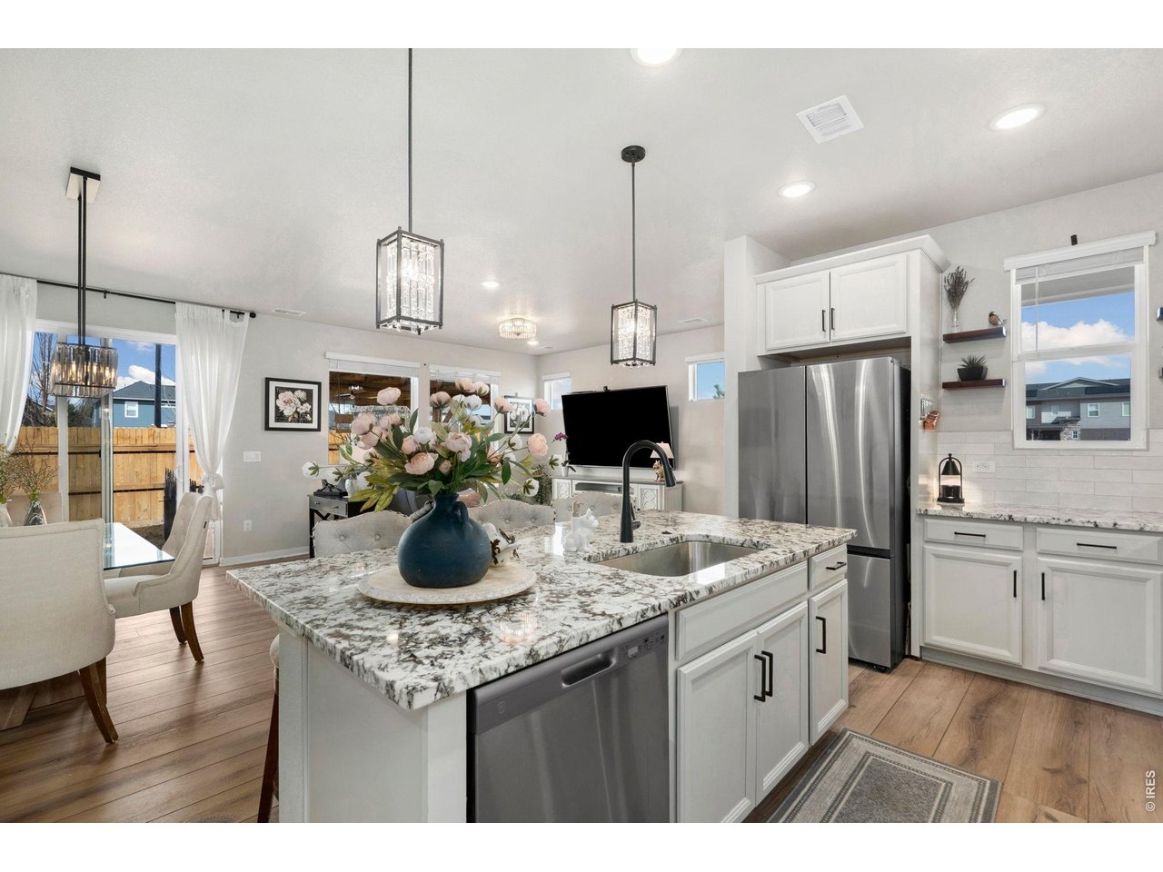 4433 Haymill Court Timnath, CO 80547 - Photo 15 of 39 a kitchen with stainless steel appliances kitchen island granite countertop a stove refrigerator and cabinets