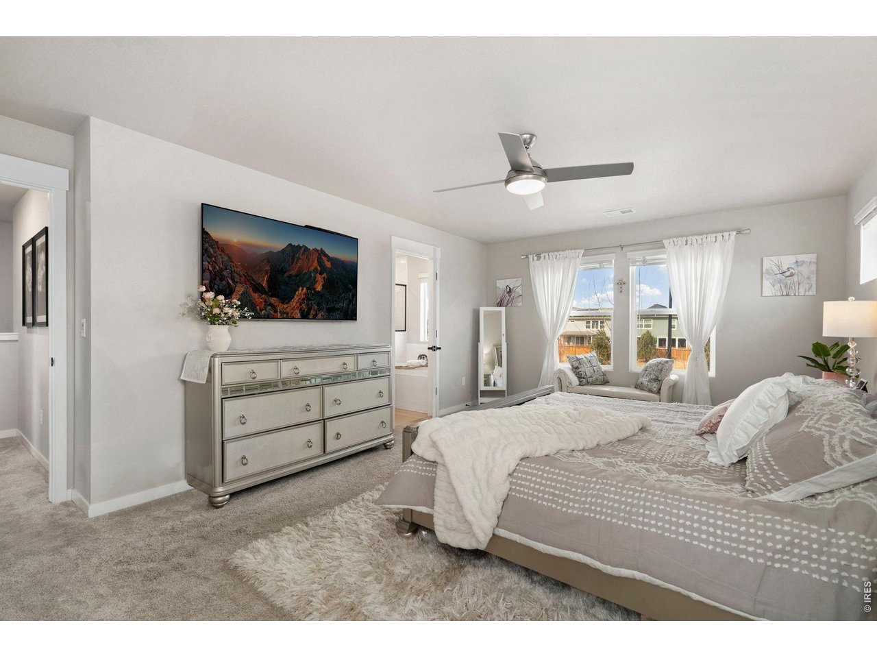 4433 Haymill Court Timnath, CO 80547 - Photo 24 of 39 a bedroom with a bed and a flat screen tv