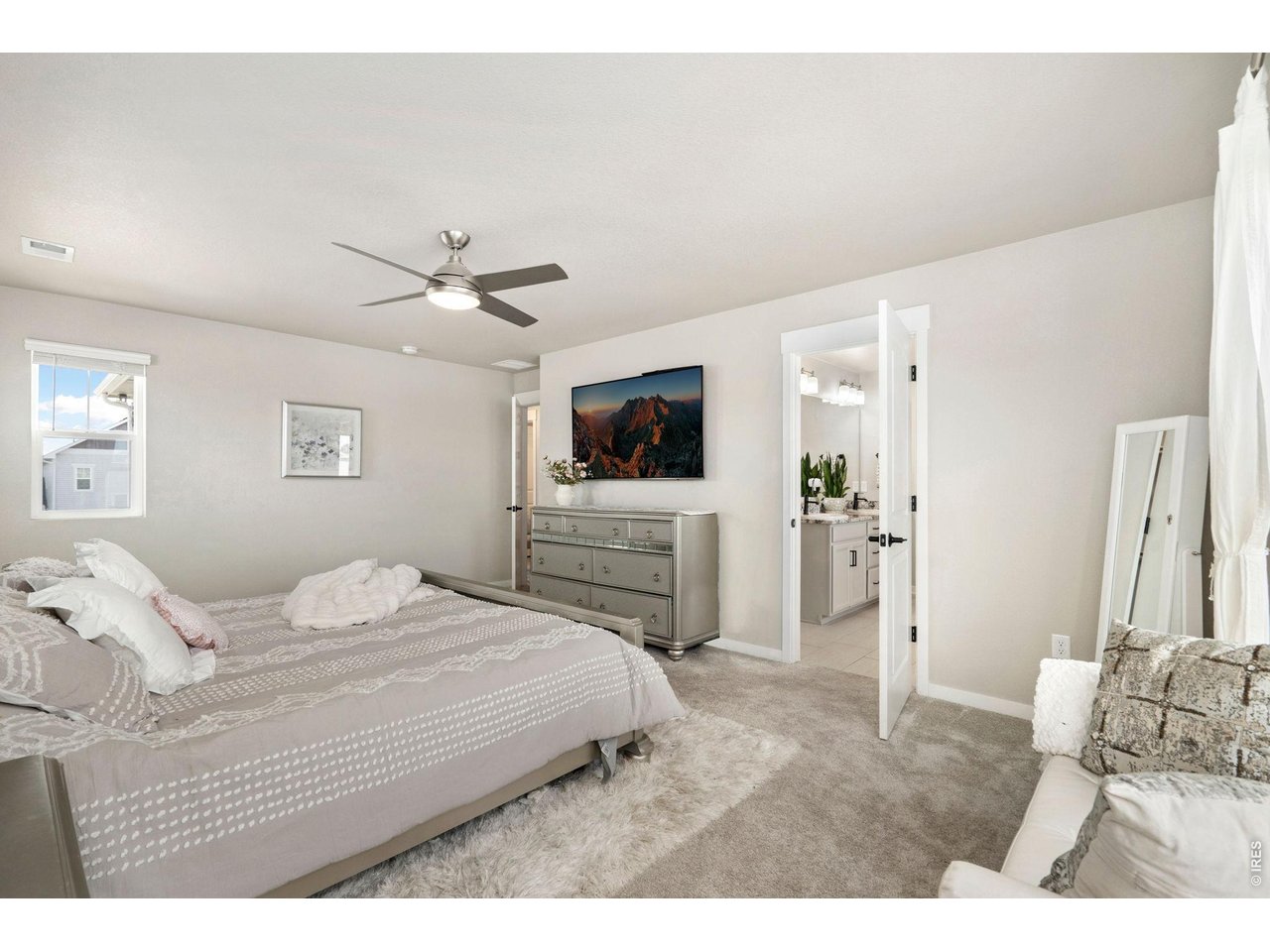 4433 Haymill Court Timnath, CO 80547 - Photo 25 of 39 a bedroom with a bed and a flat screen tv