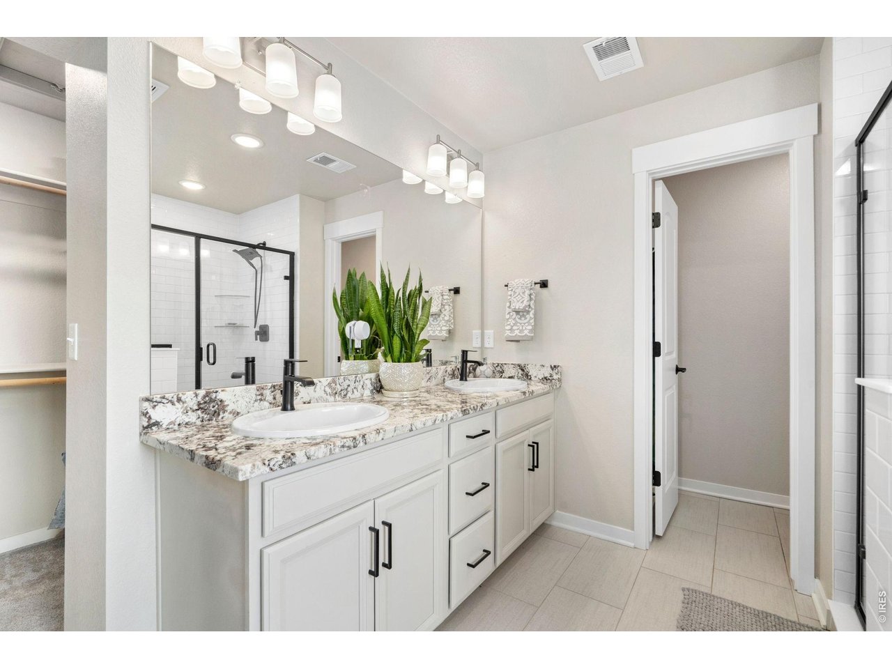 4433 Haymill Court Timnath, CO 80547 - Photo 26 of 39 a bathroom with a sink vanity granite and a mirror