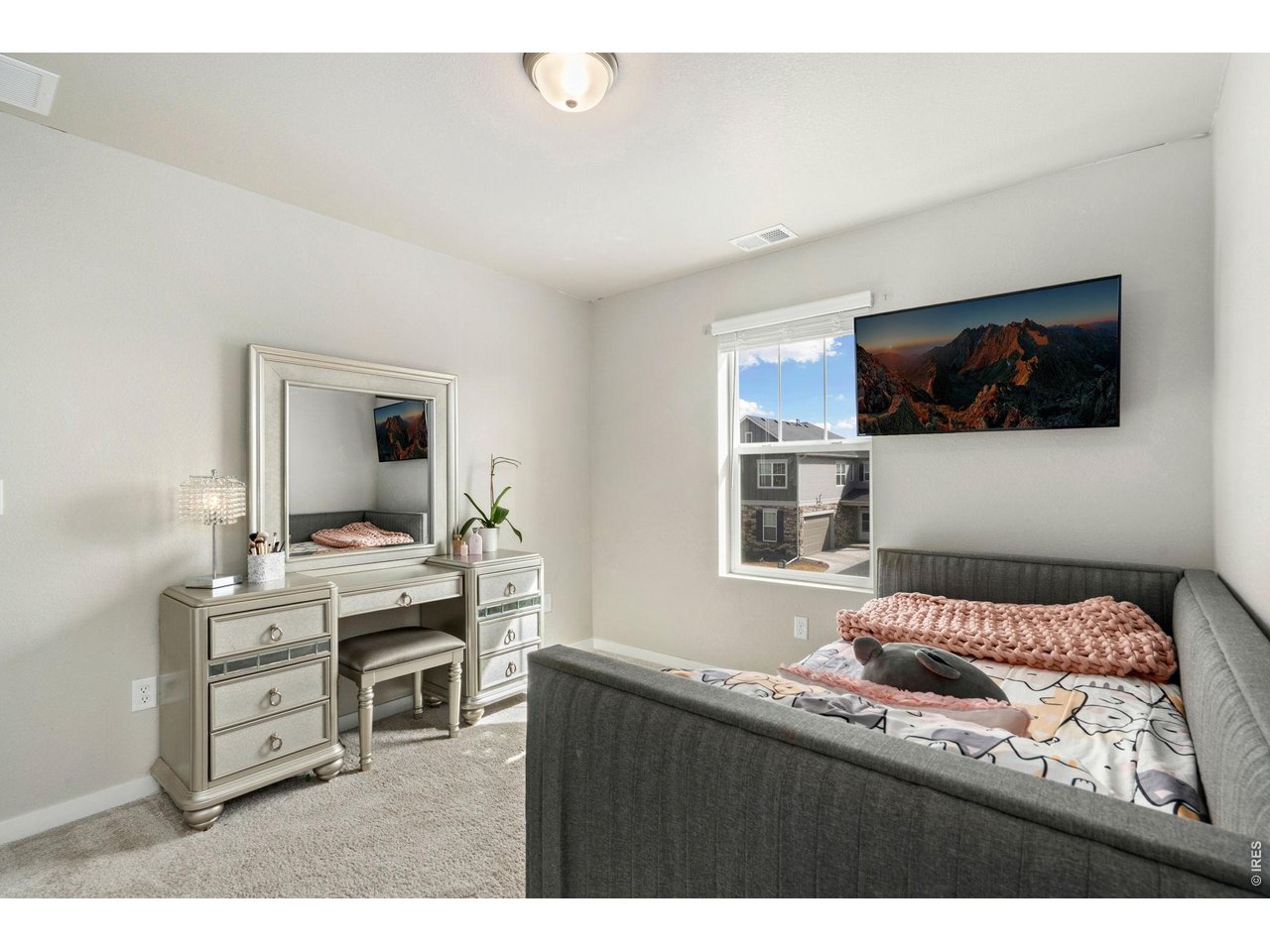 4433 Haymill Court Timnath, CO 80547 - Photo 32 of 39 a bedroom with furniture and a flat screen tv