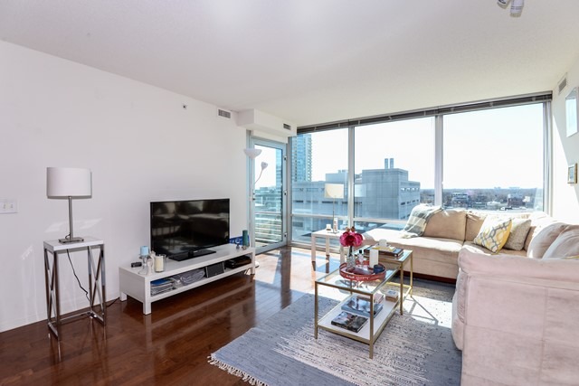 800 Elgin Road, Unit 1210 Evanston, IL 60201 - Photo 2 of 15 a living room with furniture and a flat screen tv