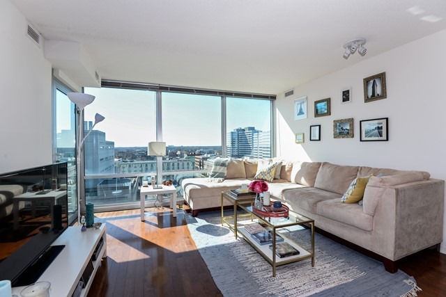 800 Elgin Road, Unit 1210 Evanston, IL 60201 - Photo 3 of 15 a living room with furniture large window and a fireplace