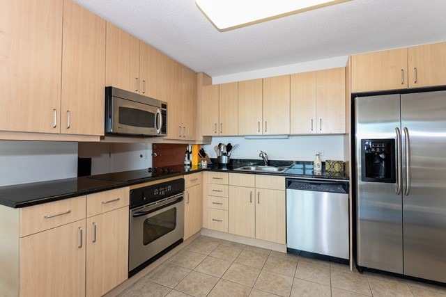 800 Elgin Road, Unit 1210 Evanston, IL 60201 - Photo 5 of 15 a kitchen with granite countertop white cabinets and stainless steel appliances