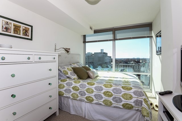 800 Elgin Road, Unit 1210 Evanston, IL 60201 - Photo 9 of 15 a bedroom with a large bed and a window