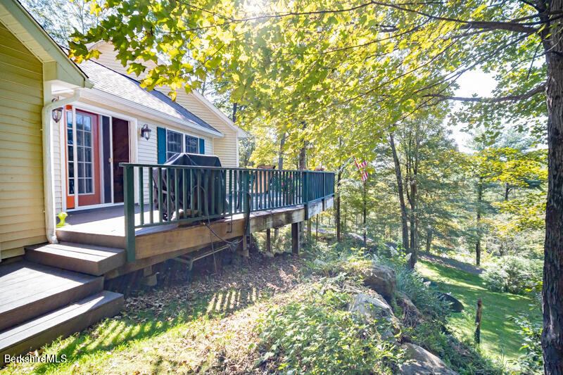 39 Pixley Road Monterey, MA 01230 - Photo 22 of 31 a view of a house with a small yard and wooden fence