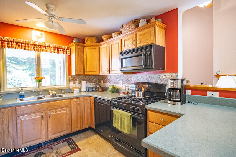 39 Pixley Road Monterey, MA 01230 - Photo 8 of 31 a kitchen with stainless steel appliances granite countertop a sink a stove a counter space and cabinets