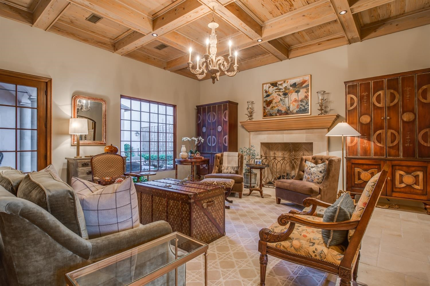 4106 103rd Street Lubbock, TX 79423 - Photo 6 of 10 a living room with furniture a chandelier and a fireplace