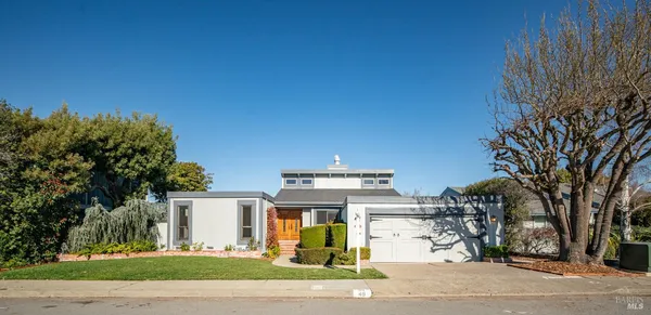 a front view of a house with a garden