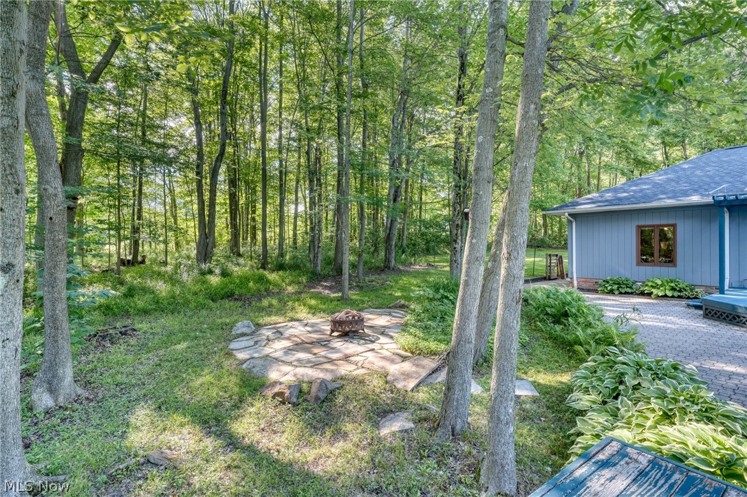 4830 Som Center Road Moreland Hills, OH 44022 - Photo 43 of 48 A storybook setting just beyond the windows: this wooded backyard wraps the home in privacy and greenery, a peaceful escape that changes its colors with every season.