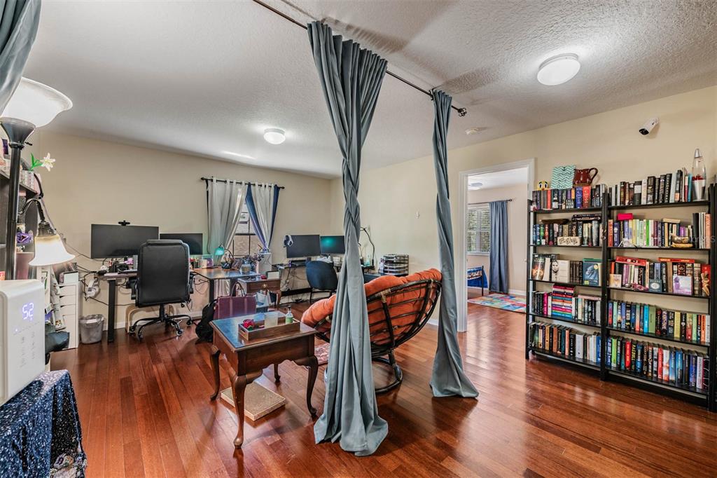 10945 Subtle Trail Drive Riverview, FL 33579 - Photo 20 of 51 a view of a livingroom with furniture and a bookshelf