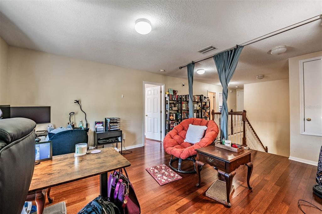 10945 Subtle Trail Drive Riverview, FL 33579 - Photo 21 of 51 a living room with furniture a rug and gym equipment