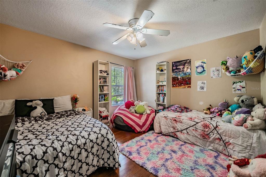 10945 Subtle Trail Drive Riverview, FL 33579 - Photo 27 of 51 a bedroom with two beds and painting on the wall