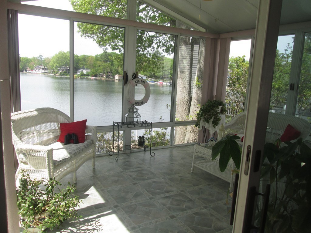 334 Killdeer Road Webster, MA 01570 - Photo 1 of 28 a living room with furniture and a floor to ceiling window