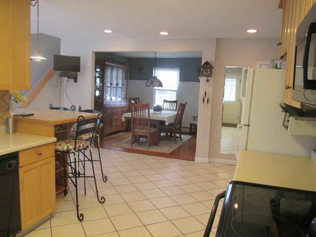 334 Killdeer Road Webster, MA 01570 - Photo 14 of 28 a living room with stainless steel appliances furniture a rug and a view of kitchen