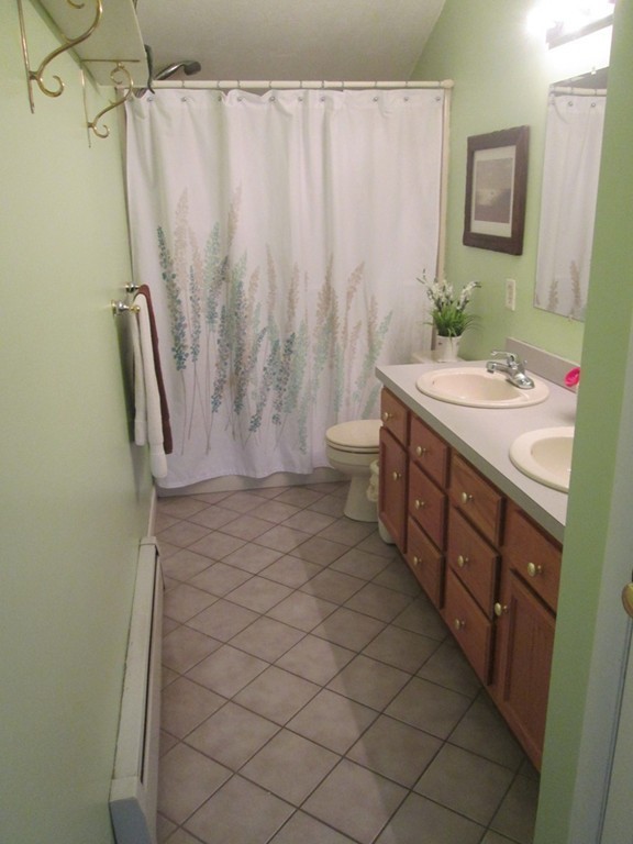 334 Killdeer Road Webster, MA 01570 - Photo 26 of 28 a bathroom with a granite countertop sink a toilet and shower