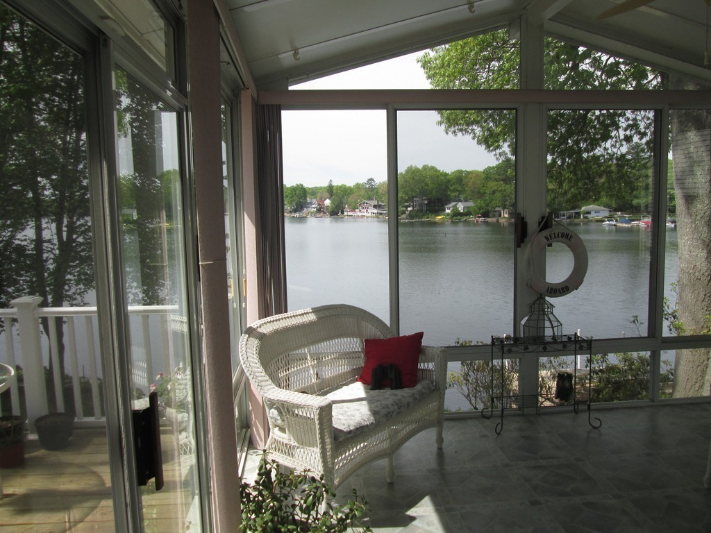 334 Killdeer Road Webster, MA 01570 - Photo 3 of 28 a lake view with a lake view and a potted plant next to a large window