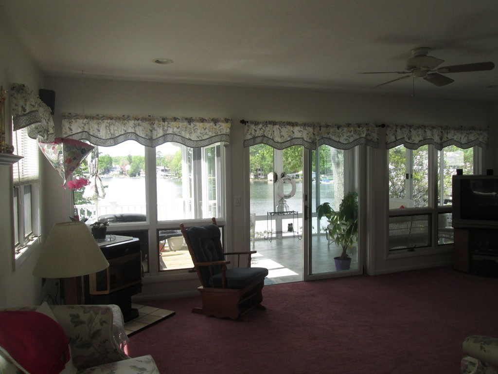 334 Killdeer Road Webster, MA 01570 - Photo 10 of 28 a living room with furniture and a floor to ceiling window