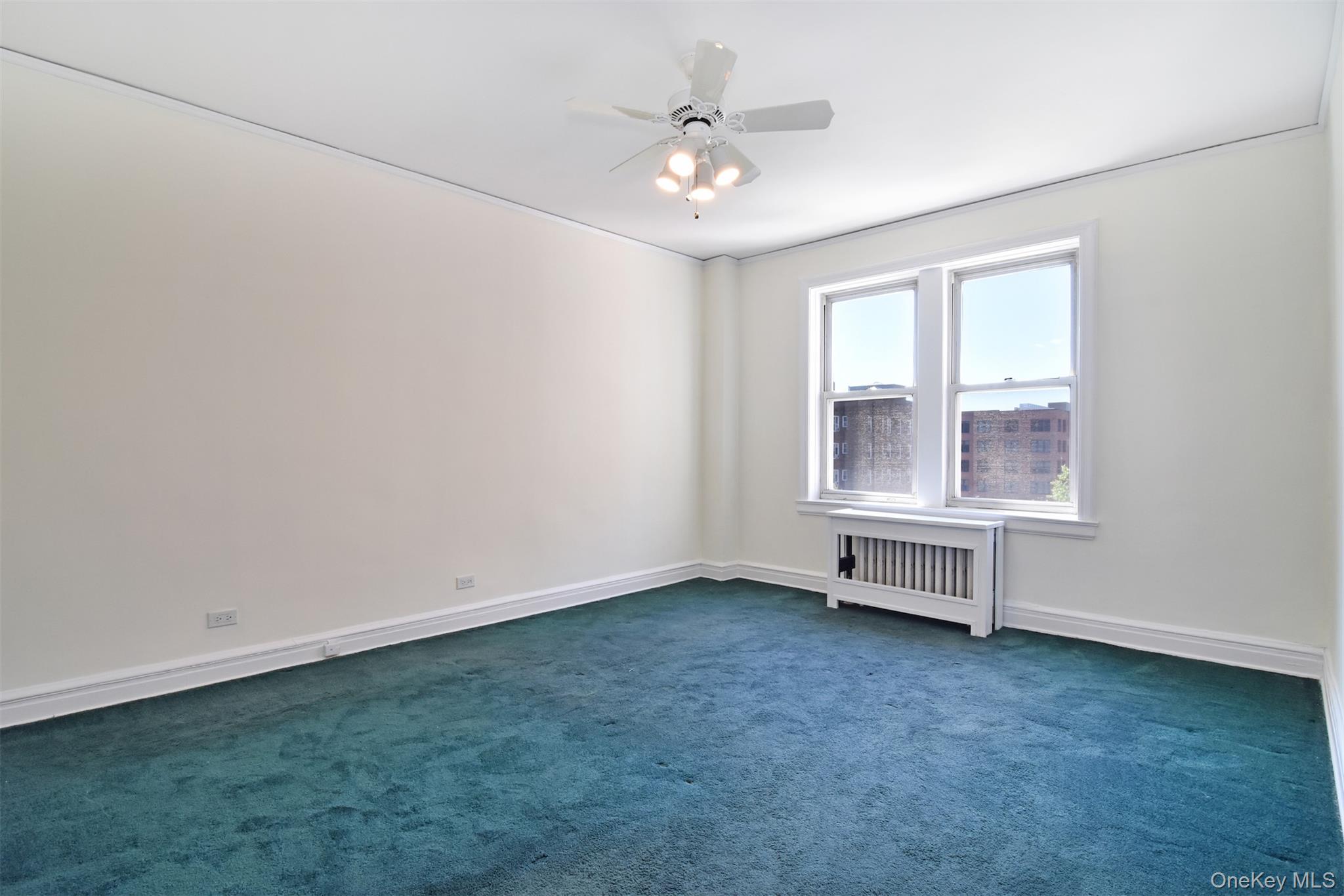 280 Bronxville Road, Unit 5W Bronxville, NY 10708 - Photo 9 of 14 A generously sized bedroom is currently carpeted, with hardwood flooring preserved underneath.
