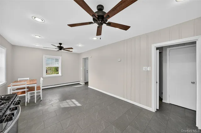 a view of workspace with furniture and ceiling fan