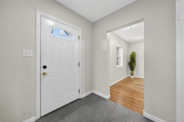 a view of a hallway view with wooden floor and staircase