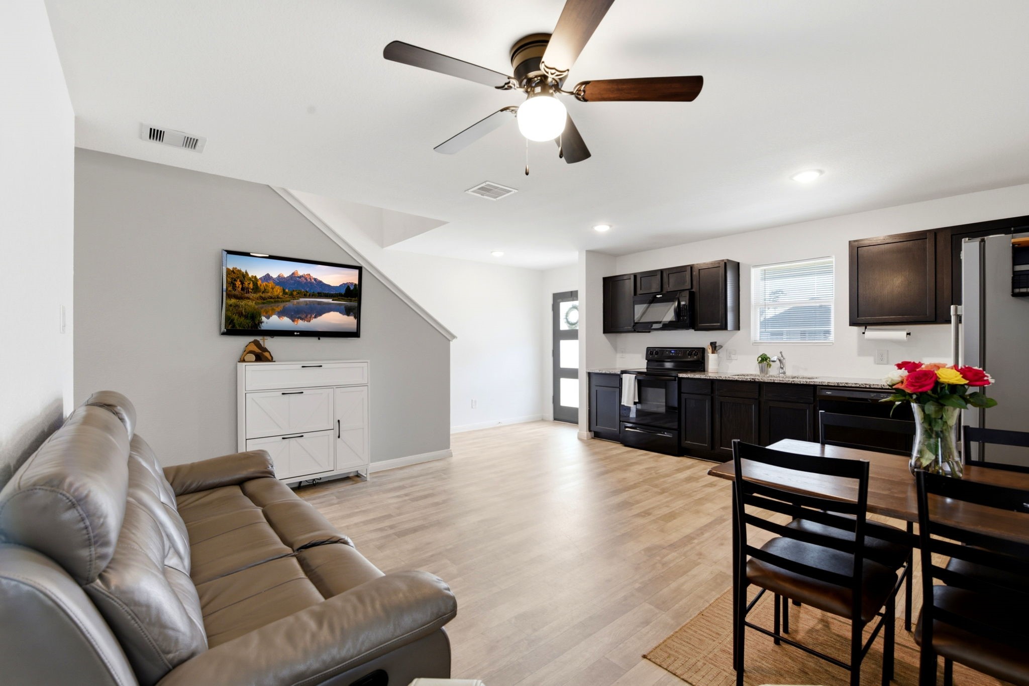 9819 Emerald Stone Way Conroe, TX 77306 - Photo 19 of 38 a living room with furniture and a flat screen tv
