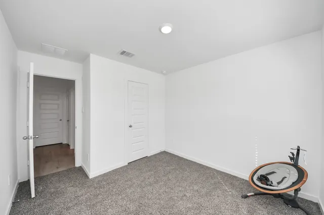 an empty room with a sink and a mirror