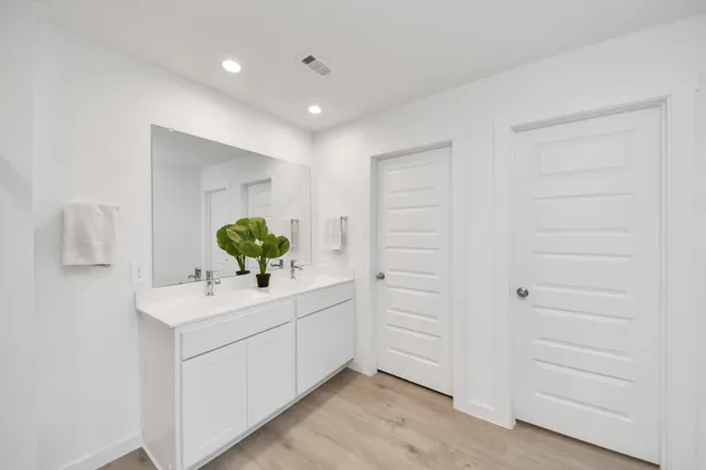 a bathroom with a sink vanity and mirror