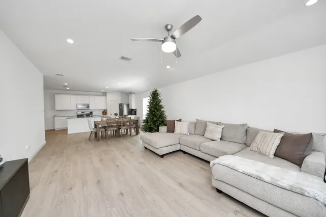 a living room with furniture and kitchen view