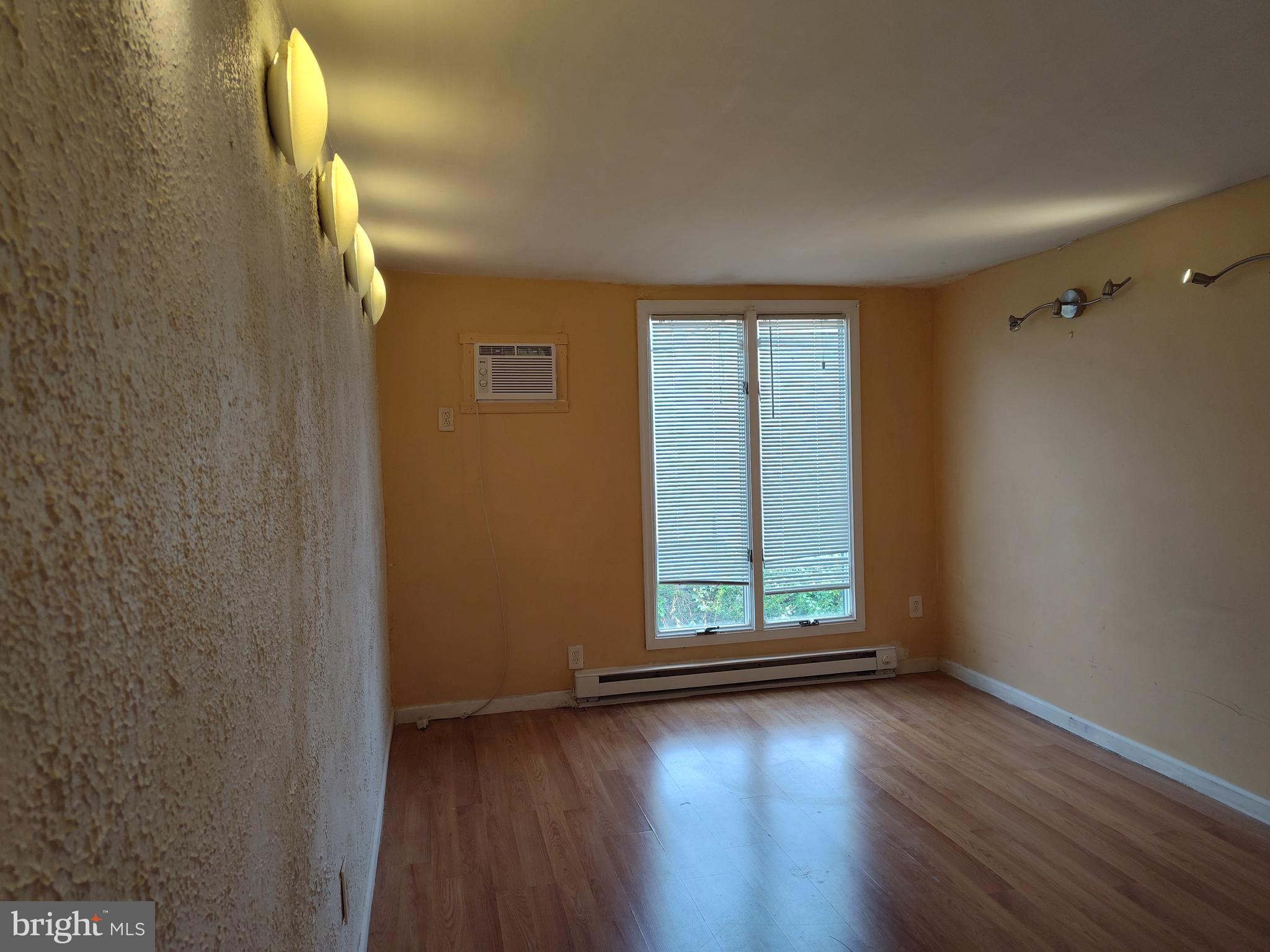 1607 Page Street Philadelphia, PA 19121 - Photo 3 of 14 wooden floor in an empty room with a window
