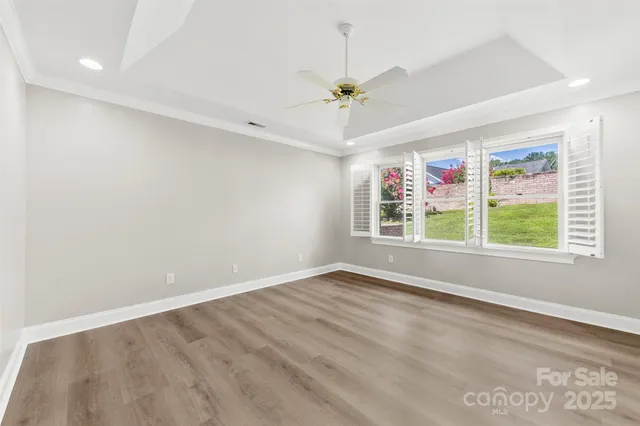 a view of a room with wooden floor and windows