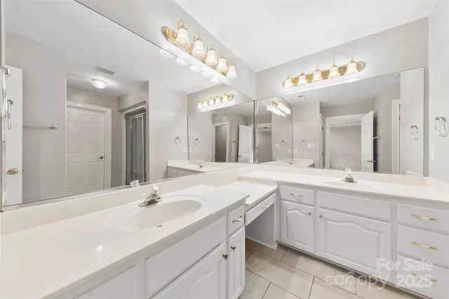 a spacious bathroom with a sink double vanity and a mirror