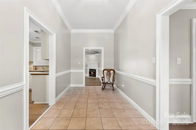 a large white kitchen with granite countertop a stove a sink and a large window