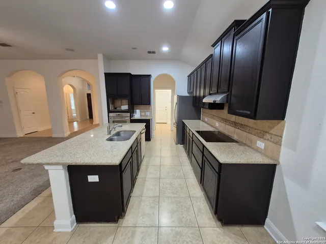 an empty room with a window and a ceiling fan