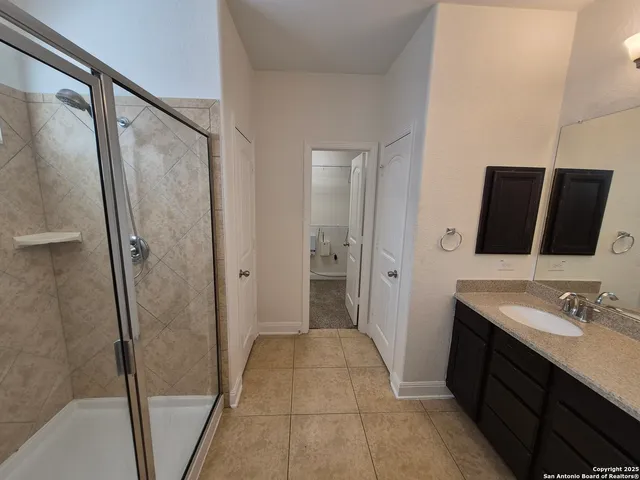 a bathroom with a glass shower door
