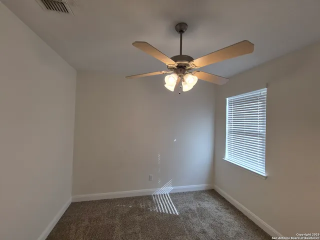 a view of a livingroom with a chandelier fan