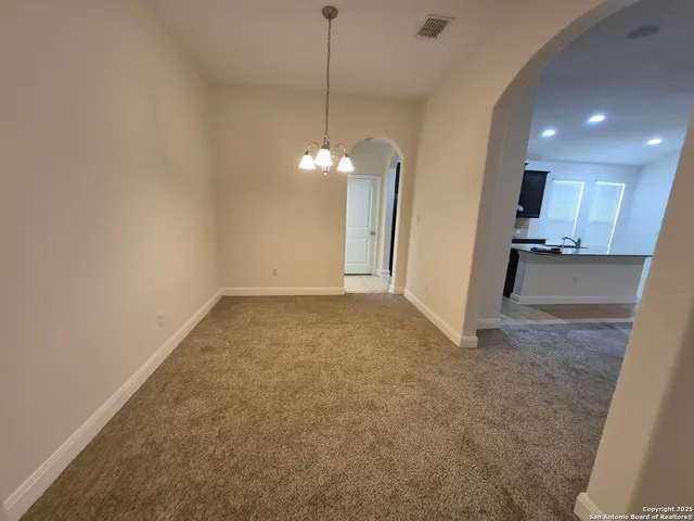 a view of a kitchen with a sink and a chandelier