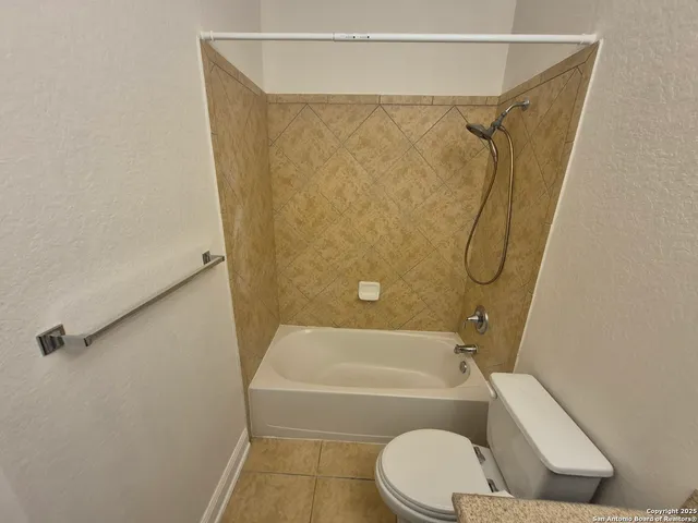 a bathroom with a toilet a sink and mirror