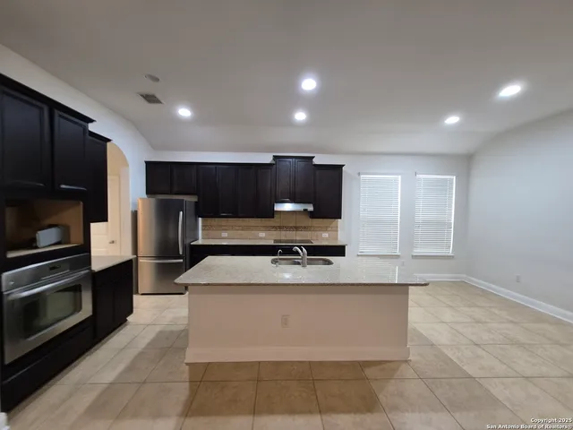 a kitchen with cabinets and stainless steel appliances