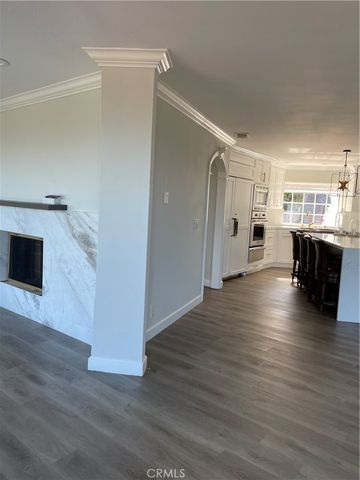 a kitchen with stainless steel appliances granite countertop a coffee maker a sink a counter space and cabinets