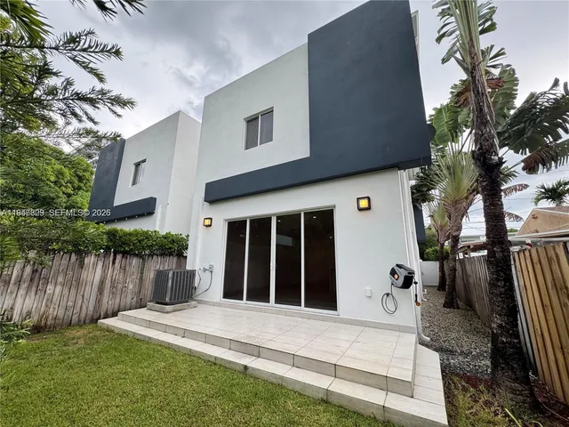 a view of house with backyard space and garden