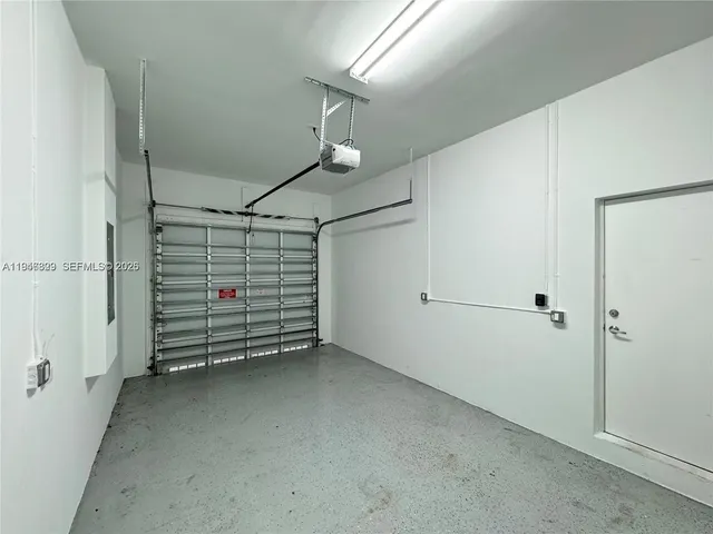 a view of room that has a white car parked