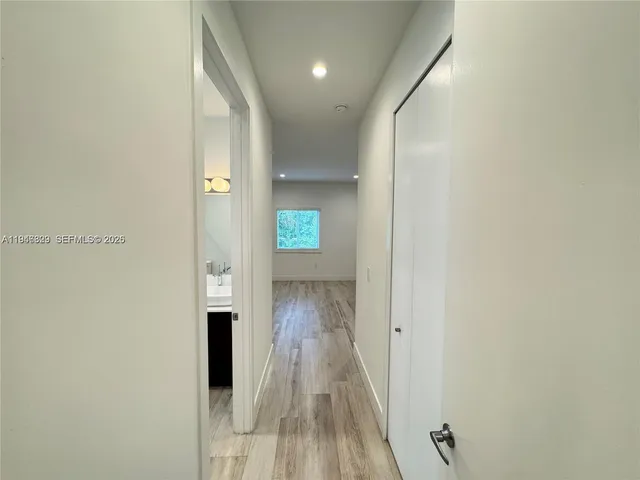 a view of hallway with wooden floor