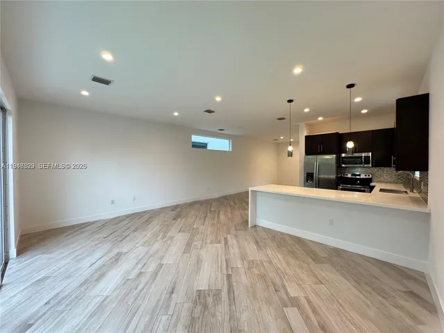 a view of kitchen and wooden floor