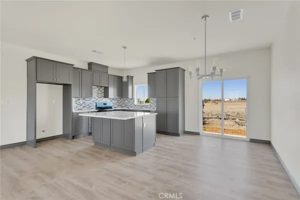 a kitchen with stainless steel appliances a refrigerator sink and cabinets