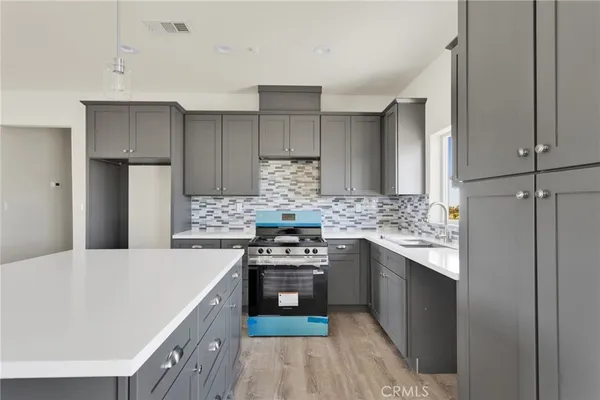 a kitchen with a stove and a refrigerator