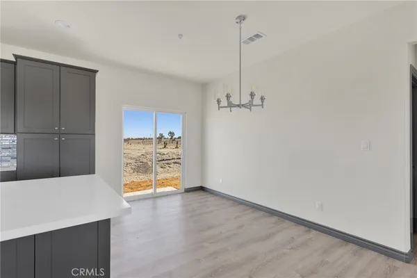 a view of an empty room with a cabinet