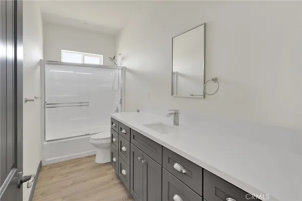 a bathroom with a sink a toilet and vanity
