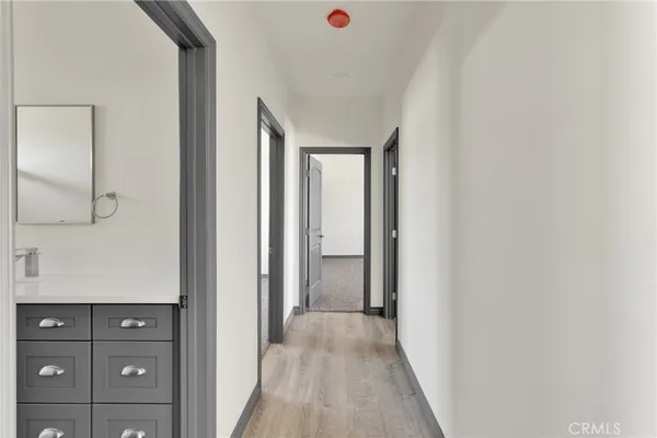 a view of a hallway with wooden floor