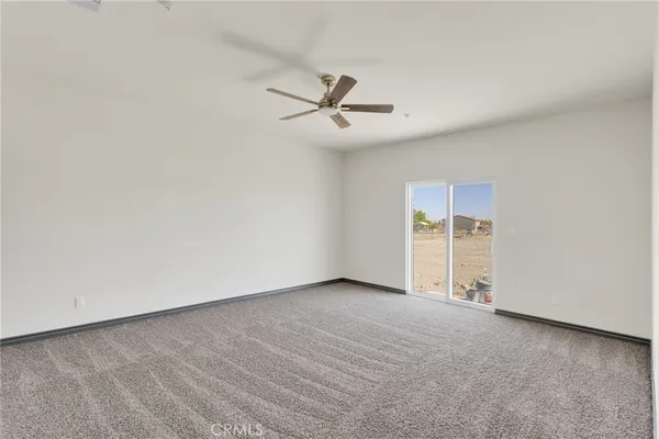an empty room with closet and windows